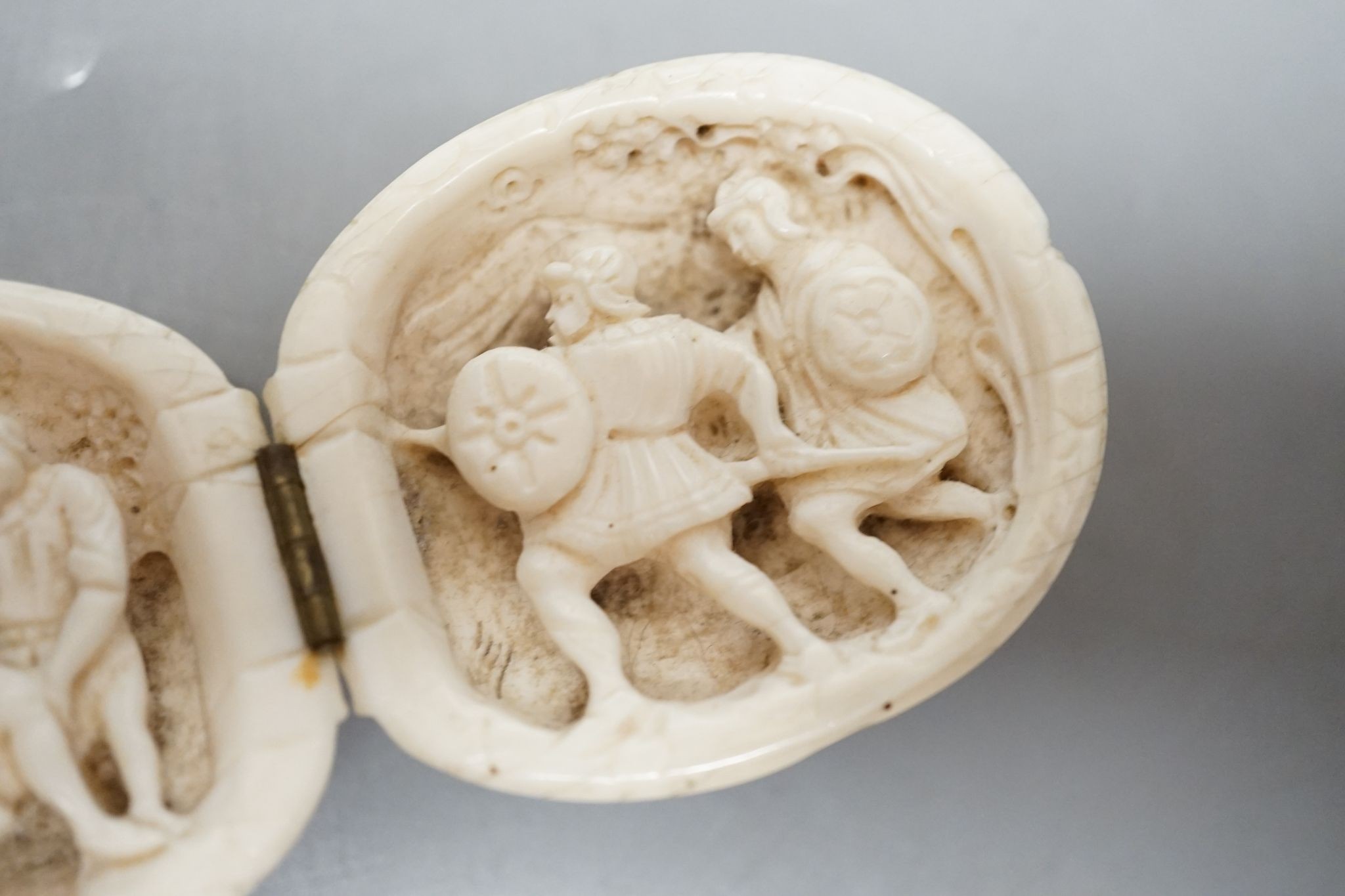 A 19th century Dieppe ivory carving, folding in two sections, 10cm. max. width